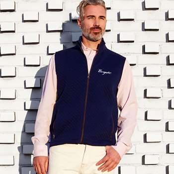 Male model wearing pink buttondown and fleece vest