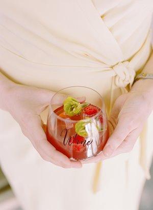 Woman in pink dress holding a wine glass 