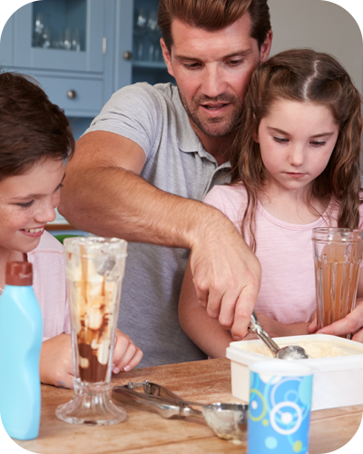 Father, son and daughter scooping up ice-cream