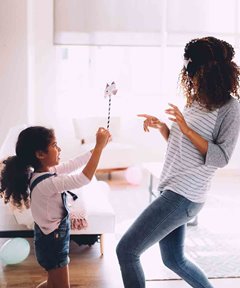 image of a mom and daughter playing in a house
