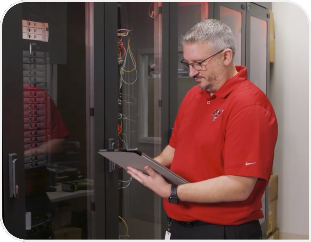 A person works in a room of technology.   