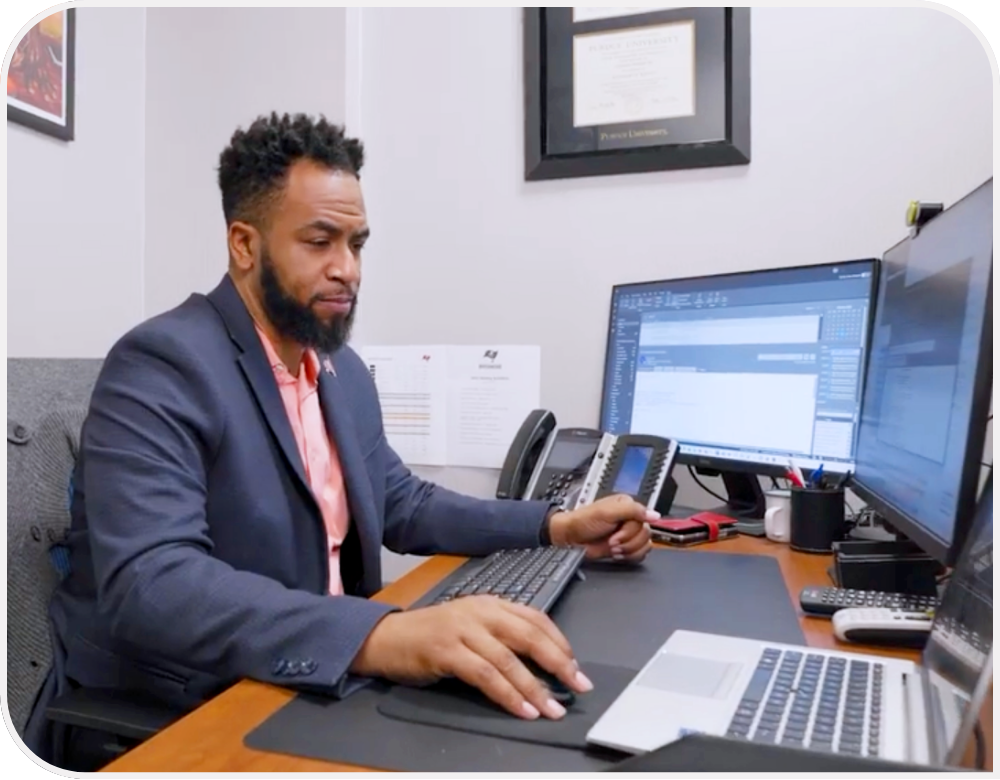 A businessperson works at a desk. 
