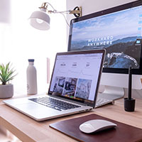 Computer Workstation, desk, with a laptop, screen, and mouse