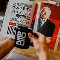 Person reading book with coffee