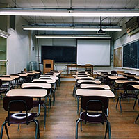 Classroom with desks, a blackboard, and whiteboard
