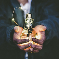 Person holding lightbulb