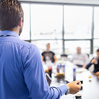 Board Room with a person presenting to a group of people